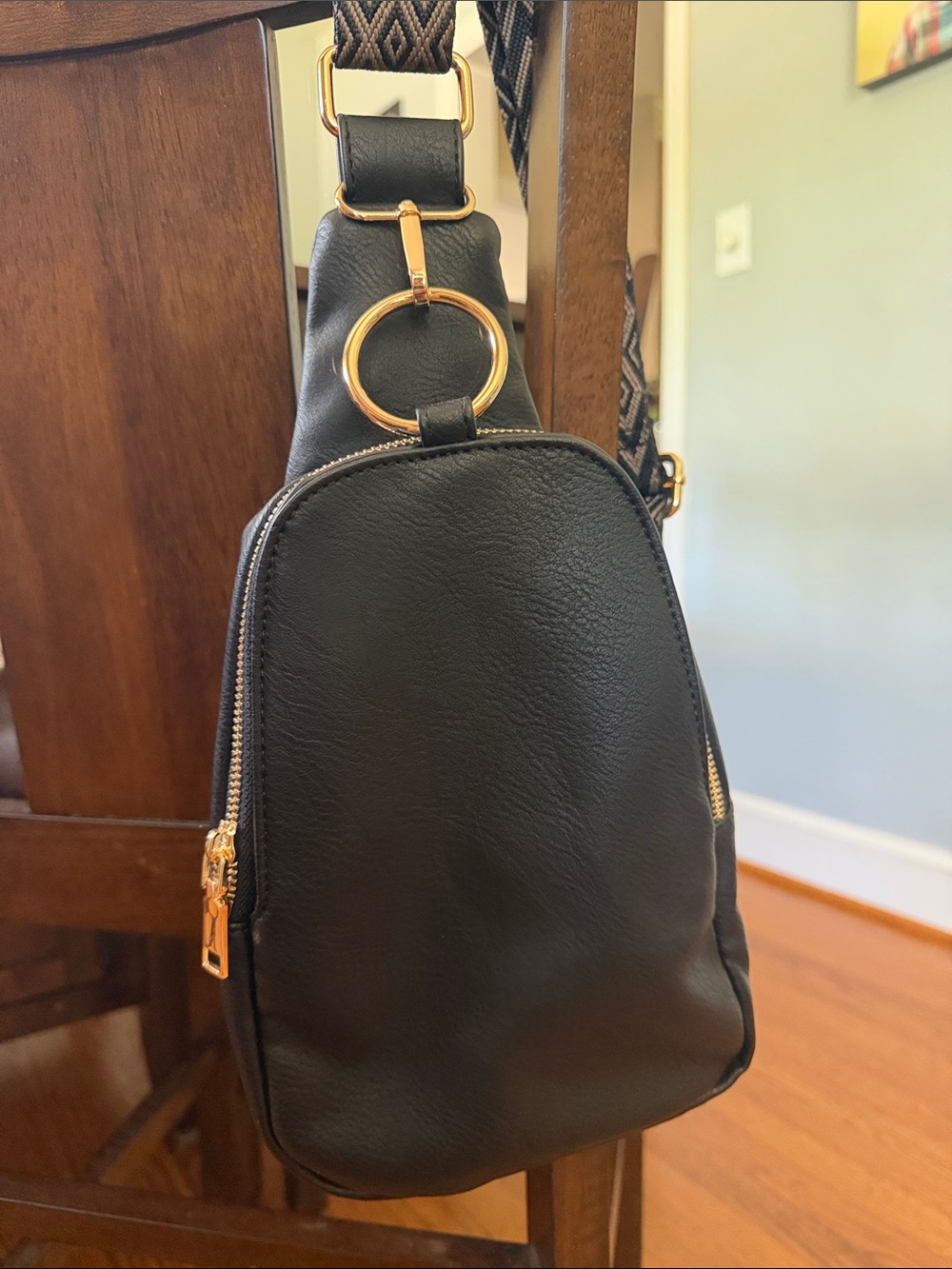 Moda Luxe Regina Sling Backpack with Gold Hardware.